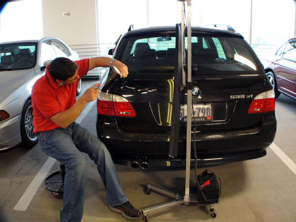 Jake Kelm repairing BMW tailgate using PDR paintless dent repair