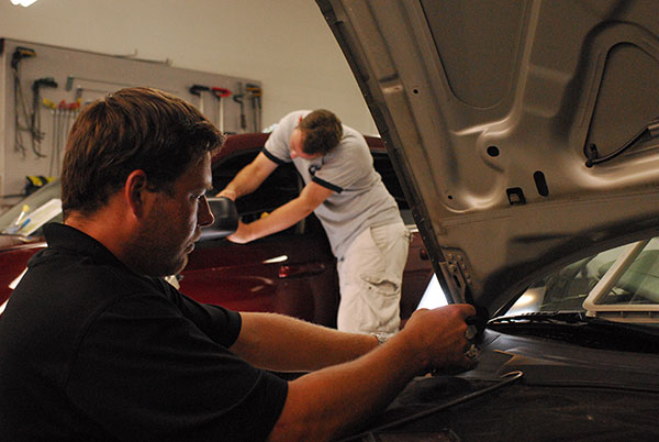 Jake Kelm and John Rutz work on PDR at their shop in Plymouth, MN