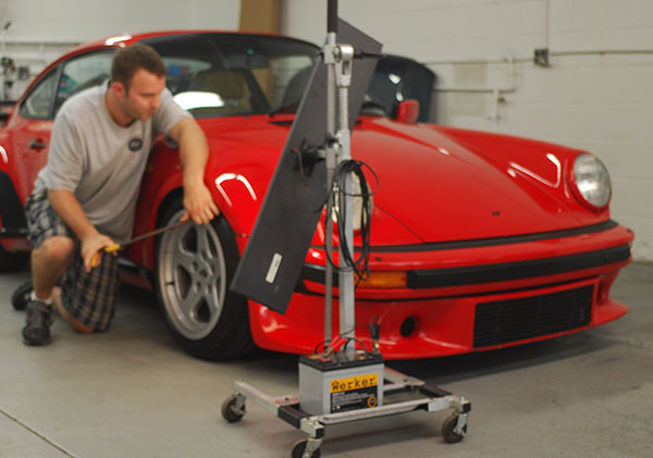 John Rutz of Dent Werks PDR working a dent on a Porsche RUF