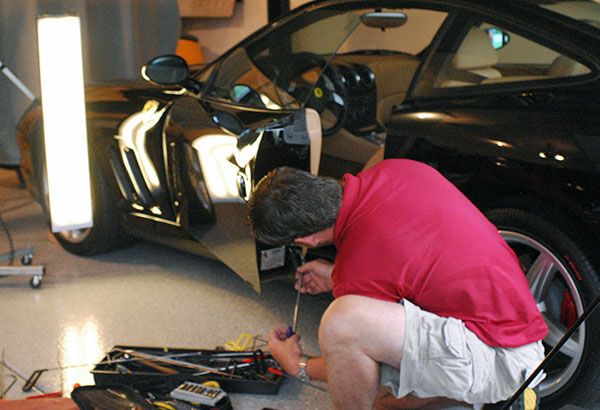 Jake Kelm repairing a Ferrari dent on location